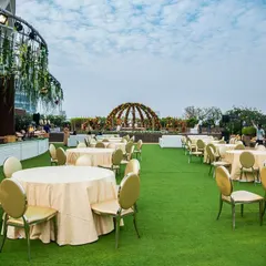 I excel at styling unique locations like this rooftop at Jade Gardens. The open-air setting with a domed floral structure creates a refreshing atmosphere for networking events or corporate celebrations, offering guests a memorable experience against the city skyline.