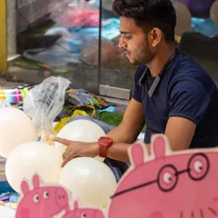 Behind the scenes of a Peppa Pig party. Our decor partners and staff work meticulously, here seen preparing the balloon arrangements.