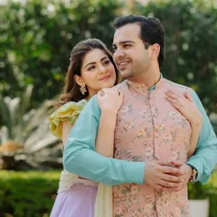 A lovely couple portrait. The bride's fresh and vibrant makeup complements the colorful and festive decor of the Mehendi ceremony.