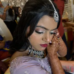 A close-up of Isha's reception makeup. Notice the soft shimmer on the eyes and the flawless, matte finish on the skin, designed to look perfect in every photograph.