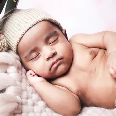 A sweet and simple close-up of a sleeping baby's face. These shots are perfect for capturing the delicate features of your newborn.