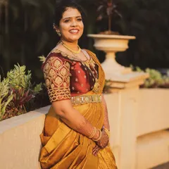 The groom's sister looks stunning in a gold Kanchipuram saree that I draped in a modern lehenga style. It's a unique and beautiful look for a close family member.