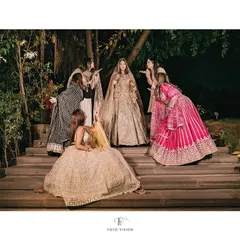 The bride and her bridesmaids sharing a fun, loving moment, blowing kisses to their friend on her special day.