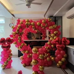 A grand heart-shaped balloon arch in red and gold, perfect for a bold statement at an anniversary party or romantic celebration at home.