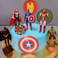 Here is another take on the popular Avengers theme, this time on a single-tier cake. It's a great option for smaller parties and includes figurines of Thor, Captain America, Iron Man, Batman, and the Hulk.
