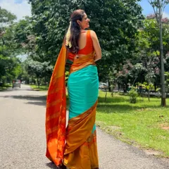 The lovely Ashika Ranganath in a custom sleeveless blouse I made. The bright orange is a perfect, vibrant contrast to her turquoise and mustard saree.