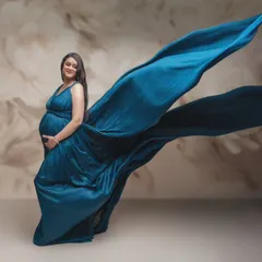 Capturing the essence of expectancy with the elegant flow of azure silk. This stunning shot is a blend of artistic vision and technical precision, highlighting the grace of motherhood.