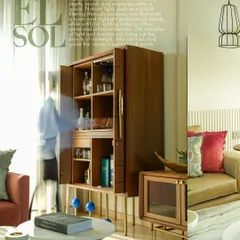 This image captures a wider view of a living room, showcasing a handsome wooden bar cabinet as the focal point. The motion blur of a person on the left adds a sense of life and movement, making the space feel dynamic and lived-in, a key aspect of my residential interior photography style.