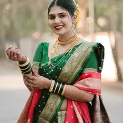 A beautiful portrait of a Marathi bride, her joy evident in her smile. We captured her adjusting her bangles, a simple gesture that adds a touch of candid grace to the shot.