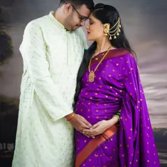 We love capturing the quiet, intimate moments between partners. This traditional maternity portrait, featuring a beautiful purple saree and ethnic jewellery, highlights the deep connection and shared anticipation of welcoming a new life.