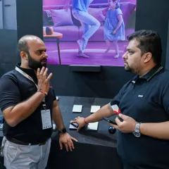 A member of my team discusses the technical specifications of my smart switches with an expo attendee. I ensure every question is answered with expert knowledge.