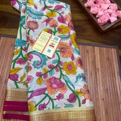 A Silk Mark certified printed Kalamkari Mysore silk saree. This piece features a vibrant floral print on a white base with a contrasting pink border.
