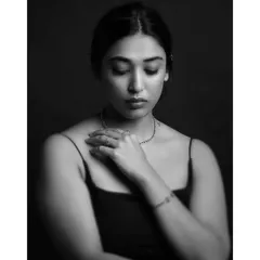 A quiet, introspective moment captured in black and white. The soft lighting and closed eyes convey a sense of peace and vulnerability, making for a deeply personal portrait.