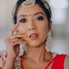 A slightly different expression, showing a soft and gentle look. This close-up is perfect for appreciating the subtle details of the makeup and the bride's natural beauty.