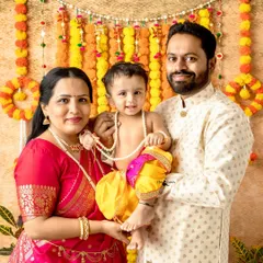 A beautiful family portrait celebrating Janmashtami. The family coordinates their outfits with the festive theme, creating a perfect, harmonious memory.