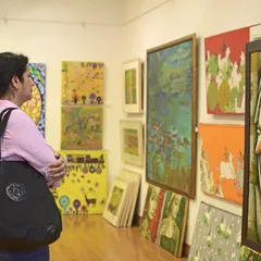 An art enthusiast immerses herself in the collection during our Art Annual 2016. We foster an environment where visitors can connect personally with the art, spending time to appreciate the details and stories behind each piece.