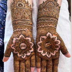 A simple word can say so much. This design features the word "LOVE" and a name hidden within beautiful floral mandalas on the palms.