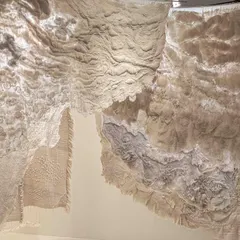A detail of the layered fabrics in the 'Sleep Sense' installation. The backlit, deckled-edged panels feel like floating clouds, creating a soothing, dream-like experience for the viewer.