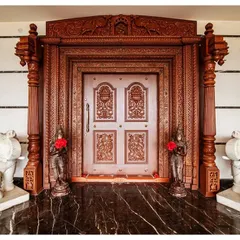 The main entrance door of "The Palace Promised" is a work of art. Flanked by marble elephants and featuring intricate hand-carved teak, this doorway sets a majestic tone, promising the grandeur that lies within this classical Indian palace.
