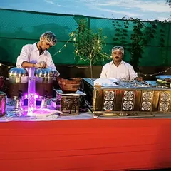 A vibrant chaat counter set up for an evening event. The twinkling lights and delicious street food create a magical and festive atmosphere.