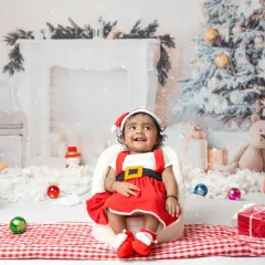 A little one's first Christmas. My festive mini sessions include adorable Santa outfits and a winter wonderland setup to capture this special milestone.