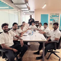 United we start, motivated we heal. A photo of our team during a meeting, where we collaborate and strategize to provide the best possible care for our clients.