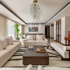 The living room of the Parishram residence is a study in composed elegance. We used a neutral color scheme for the furnishings to create a calm backdrop, allowing the client's vibrant art collection and the handcrafted piano to become the focal points.