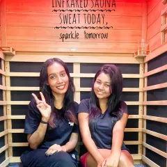 Sweat today, sparkle tomorrow. Here you can see two clients enjoying the gentle warmth of our private infrared sauna cabin. The experience is designed to boost circulation and detoxify your skin from the inside out, leaving you with a healthy glow.