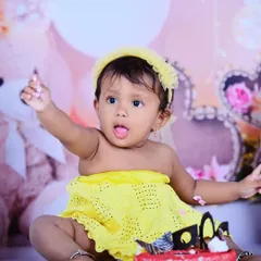 A little bit of cake and a whole lot of cute! This baby girl is enjoying her first birthday cake smash, and her expression is absolutely priceless.