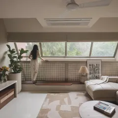 A moment of quiet reflection by a large window. I design these spaces to connect the inhabitants with the view outside, providing a peaceful spot to pause and observe.