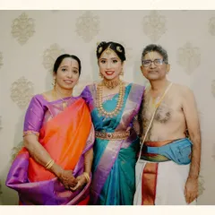 A classic family portrait of the bride with her parents. Capturing these formal portraits is essential to create a complete wedding album for generations to enjoy.