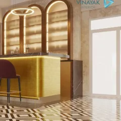 Another view of the bar, highlighting the stunning gold mosaic tiles on the counter front and the arched, backlit shelving. These details, along with the ring pendant lights, add a layer of glamour and sophistication.