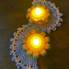 A shorter version of my tealight holder runner, perfect for smaller tables or sideboards. This two-light piece in a neutral color adds a subtle, elegant touch to your festive decorations.