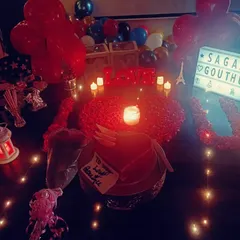 Your special one deserves something extra. This intimate setup features a personalized lightbox, rose petals spelling 'I ❤️ U', and soft candlelight, all starting from just ₹499.