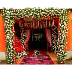 A dense and luxurious floral entrance arch. The abundance of fresh flowers creates a stunning and fragrant gateway, making for an unforgettable first impression and a perfect photo opportunity.