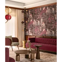 We love to weave a narrative of texture and layers, transforming a home into a vibrant, artful canvas. Here, a bold magenta velvet sofa and dramatic wallpaper create a symphony of color that redefines contemporary elegance and makes the formal living room a visual delight.