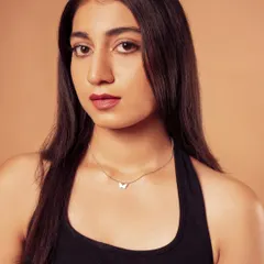 A clean, simple portrait that beautifully showcases a delicate butterfly pendant necklace. This type of shot is perfect for minimalist jewelry brands.