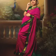 In this frame, we recreated a regal setting complete with a peacock. The mother-to-be's pose is one of quiet confidence and grace, her pink and green saree adding a vibrant touch to this artistic maternity portrait.