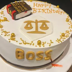 A birthday cake for the "Boss," decorated with the scales of justice. It's a fun way we celebrate our profession and our seniors in the office.