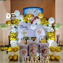 For baby Diarra's Christening, we designed this angelic theme with gold and white balloons, custom-printed pedestals, and marquee lights. The backdrop features an image of Jesus, adding a divine touch.