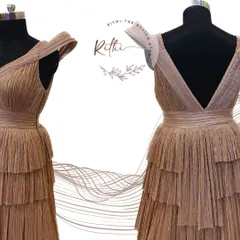 The front and back view of the rose gold gown, highlighting the sculpted shoulders and deep V-back.
