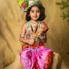 A beautiful portrait of a young girl dressed as Lord Krishna, complete with a peacock feather turban and traditional attire. A wonderful way to celebrate culture.