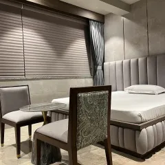 This bedroom in a Juhu residence showcases our focus on texture and bespoke details. The design features a custom upholstered bed and headboard, paired with chairs that blend classic forms with contemporary paisley fabric.