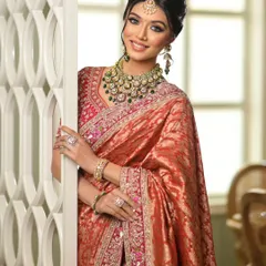 A happy bride peeking through, showcasing the elegant drape of her Banarasi saree.