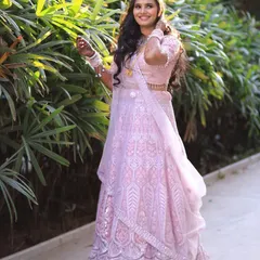 A vision in pink. This beautiful client is glowing in a light pink embroidered lehenga, a perfect choice for an outdoor engagement or roka ceremony.