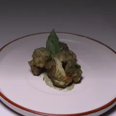My signature herb-crusted cauliflower starter is a favorite among vegetarians. It's delicate, earthy, and served with a complementary sauce for a sophisticated first course.