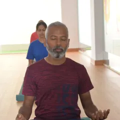 A student sits in quiet meditation, a cornerstone of our practice and a key component of our teacher training courses.
