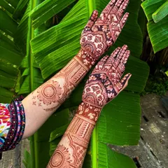 The result of our 100% organic, self-made henna paste. This photo shows the deep, rich maroon stain after it has fully matured, set against a natural backdrop to highlight its true color.