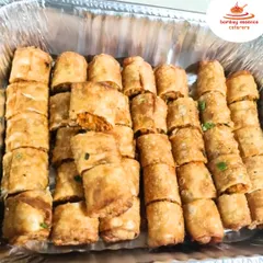 Appetizers are a popular choice for our bulk delivery. Here's a tray of our crispy vegetable spring rolls, perfectly fried and ready to be enjoyed at your home party or gathering.