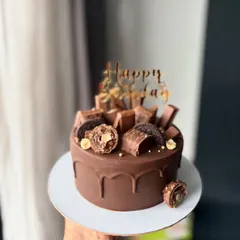 You can never go wrong with a classic chocolate cake. This one is covered in a rich chocolate drip and topped with Ferrero Rochers, Oreos, and chocolate pieces.